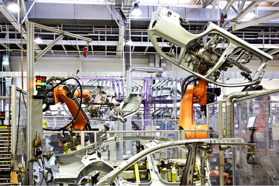 Robotic arms at work on a vehicle assembly line.