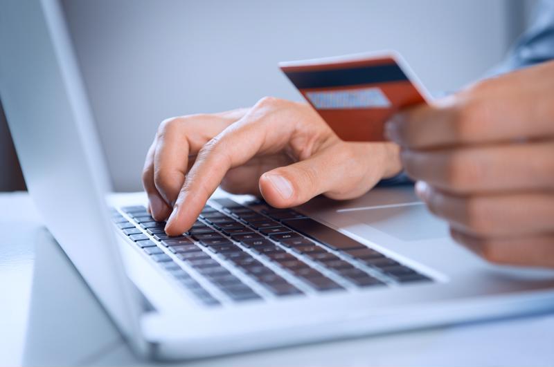 Man using a credit card to shop online