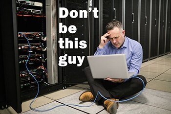 Book a demo man with laptop on floor image